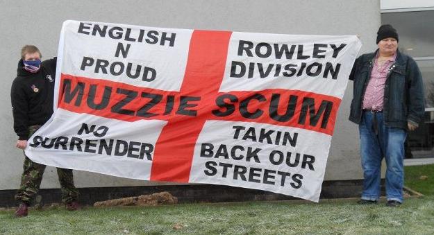 Kevin Smith with 'Muzzie Scum' banner