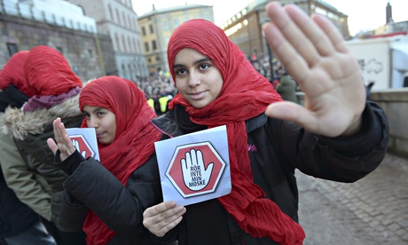 Girls bear leaflets reading: 'Don't touch my mosque' at a demonstration in Stockholm, Sweden