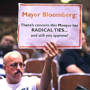 A demonstrator holds a sign during a Landmarks Commission's hearing on the proposed Cordoba Mosque to be built near the site of the former World Trade Center in New York