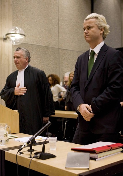Right-wing Dutch MP Geert Wilders stands next to his lawyer in an Amsterdam court charged with inciting hatred and discrimination against Muslims